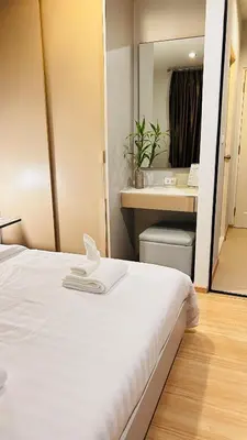 a hotel room with a white bed and a mirror at Zcape 1 Condo Cherngtalay Thalang Gym pool Wifi Netflix Walk to All in Ban Thalat Choeng Thale