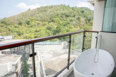 a bathroom with a tub and a sink on a balcony at Utopia Karon - Karon Beach in Karon Beach
