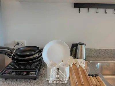 a kitchen counter with a whisk and utensils next to a sink at THe bell chalong phuket 19 in Ban Klang