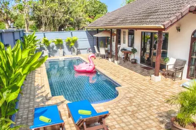 a swimming pool with a pink flamingo in a backyard at Serenity Holiday Pool Villa, Bangtao Beach in Surin Beach