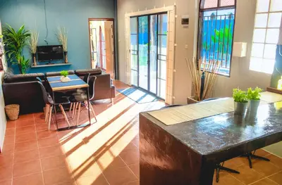 a living room with a table and chairs at Serenity Holiday Pool Villa, Bangtao Beach in Surin Beach
