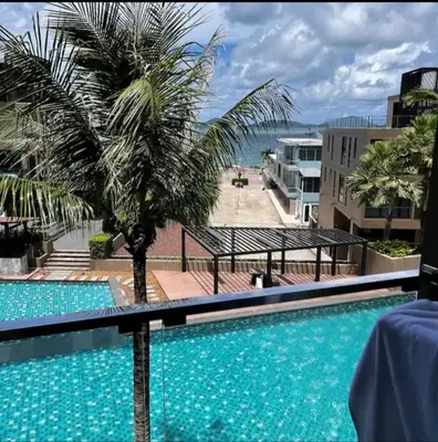 a view from the balcony of a resort with a swimming pool at Phuket, The Pixcel Cape Panwa Condo in Ban Ao Makham