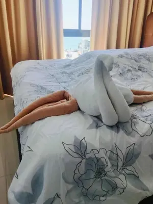 a bed with a stuffed animal laying on it at Phuket, The Pixcel Cape Panwa Condo in Ban Ao Makham