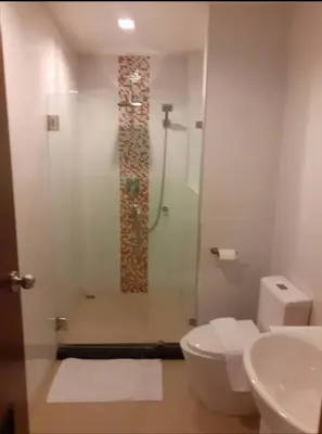 a bathroom with a shower and a toilet and a sink at Phuket, The Pixcel Cape Panwa Condo in Ban Ao Makham