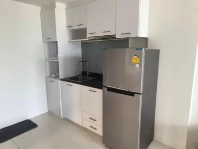 a kitchen with a stainless steel refrigerator and white cabinets at Phuket, The Pixcel Cape Panwa Condo in Ban Ao Makham