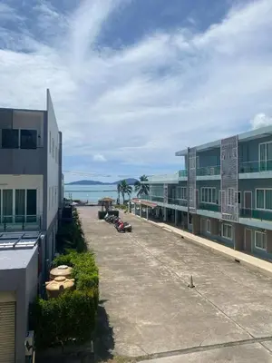 arial view of a building with the ocean in the background at Phuket, The Pixcel Cape Panwa Condo in Ban Ao Makham