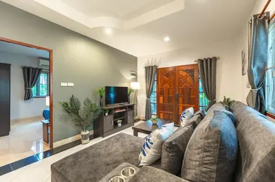 a large living room with a couch and a tv at Coastline Pearl Holiday Home, Bangtao Beach in Ban Thalat Choeng Thale