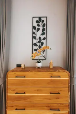 a wooden dresser with a vase of flowers on top at Botanic Modern loft Villa Private Pool 10 min BangTao in Ban Pak Lak