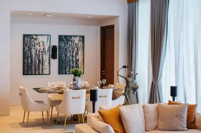 a living room with a couch and a dining room table at Botanic Modern loft Villa Private Pool 10 min BangTao in Ban Pak Lak