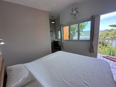 a bedroom with a white bed and a window at Pangea Stay in Kathu