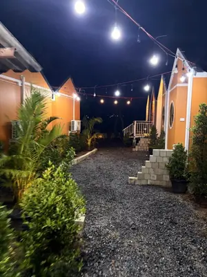 a courtyard of a house at night with lights at Pangea Stay in Kathu