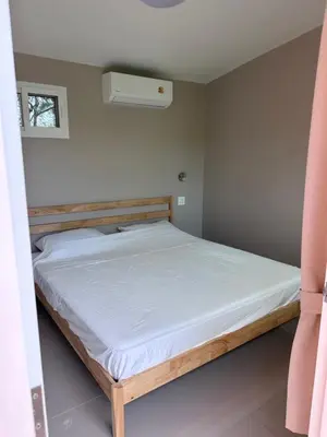 a bedroom with a bed with a white mattress at Pangea Stay in Kathu