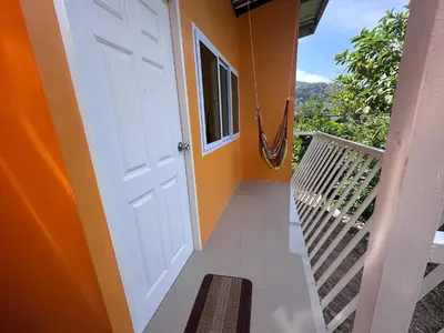 a white door on a house with a balcony at Pangea Stay in Kathu