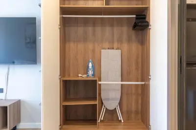 a room with a closet with a chair in it at New studio near Boat Avenue by Lofty in Bang Tao Beach