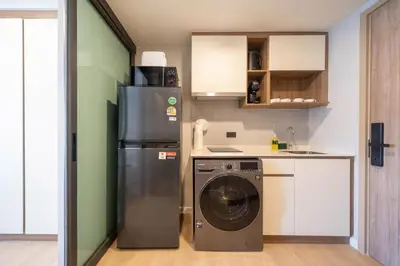 a kitchen with a refrigerator and a washing machine at New studio near Boat Avenue by Lofty in Bang Tao Beach