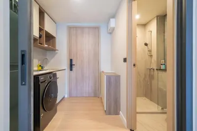a bathroom with a washer and dryer in a room at New studio near Boat Avenue by Lofty in Bang Tao Beach
