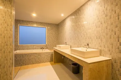 a bathroom with two sinks and a tub and a window at First Ao Nang Private Pool Villa in Ao Nang Beach