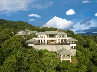 an aerial view of a house on a hill with trees at Baan Paa Talee Estate - SHA Extra Plus in Kamala Beach