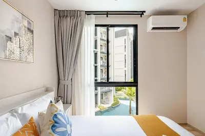 a bedroom with a bed and a large window at The Title Halo1 350 m to NaiYang Brand-New 1BR in Nai Yang Beach