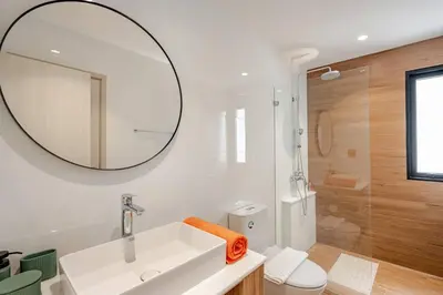 a white bathroom with a sink and a mirror at The Title Halo1 350 m to NaiYang Brand-New 1BR in Nai Yang Beach