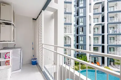 a balcony with a view of a building at The Title Halo1 350 m to NaiYang Brand-New 1BR in Nai Yang Beach