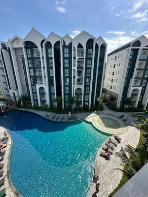 a large swimming pool in front of a large building at The Title Halo1 350 m to NaiYang Brand-New 1BR in Nai Yang Beach