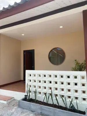 a room with a white fence and a mirror at Muttafa House in Nai Yang Beach