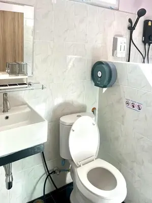 a bathroom with a white toilet and a sink at Yada House Sunny Place in Ban Bo Han