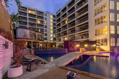 a swimming pool in an apartment complex with buildings at C229 1BR Studio Sea View 850m to Beach Gym in Patong Beach