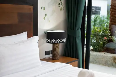 a bedroom with a bed and a lamp on a night stand at Andaman Paradise 1 - Luxury 3-Bedrooms Pool Villa in Rawai Beach