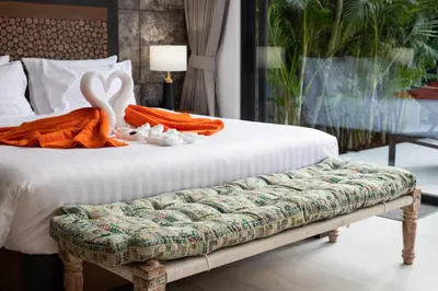 a bed with a bench with a swan on it at Andaman Paradise 1 - Luxury 3-Bedrooms Pool Villa in Rawai Beach