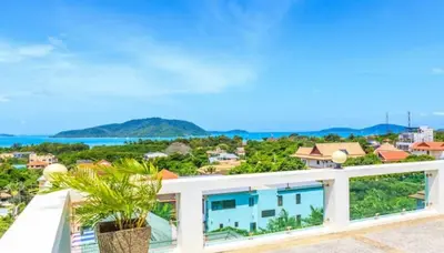 a view of the ocean from the balcony of a house at C230 Chill 1BR Sea View, Near Beach & Muay Thai in Rawai Beach