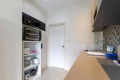 a kitchen with a white door and a white pantry at C230 Chill 1BR Sea View, Near Beach & Muay Thai in Rawai Beach