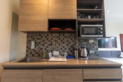a kitchen with a sink and a microwave at C230 Chill 1BR Sea View, Near Beach & Muay Thai in Rawai Beach