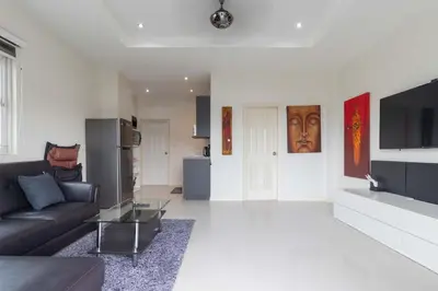 a living room with a couch and a television at C230 Chill 1BR Sea View, Near Beach & Muay Thai in Rawai Beach