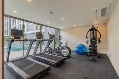 a gym with two treadmills and two exercise bikes at C231 Brand-New 1BR Prime Spot Pool&Gym Near Beach in Bang Tao Beach