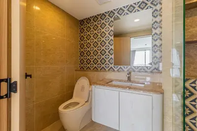 a bathroom with a toilet and a sink and a mirror at C231 Brand-New 1BR Prime Spot Pool&Gym Near Beach in Bang Tao Beach