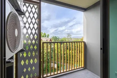a room with a balcony with a fan at C227 Brand New Condo Near Top Phuket Beach Clubs in Bang Tao Beach