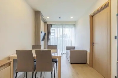 a living room with a dining room table and chairs at C227 Brand New Condo Near Top Phuket Beach Clubs in Bang Tao Beach