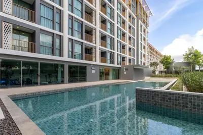 a swimming pool in front of a building at C227 Brand New Condo Near Top Phuket Beach Clubs in Bang Tao Beach