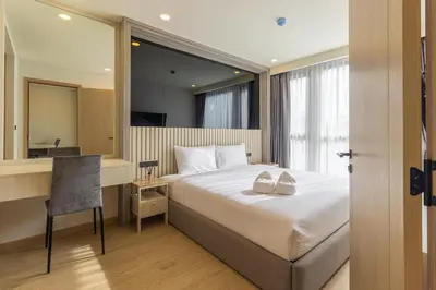a bedroom with a bed and a desk and a mirror at C228 Brand New Condo Near Beach & Prime Location in Bang Tao Beach