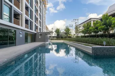 a swimming pool in the middle of a building at C228 Brand New Condo Near Beach & Prime Location in Bang Tao Beach