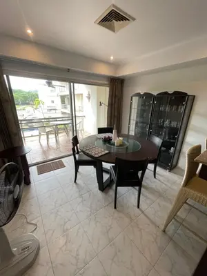 a living room with a table and chairs and a balcony at Rawai Condominium in Ban Saiyuan (1)