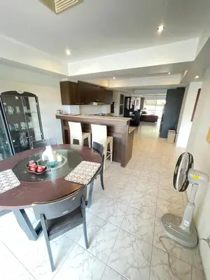 a kitchen and dining room with a table and chairs at Rawai Condominium in Ban Saiyuan (1)