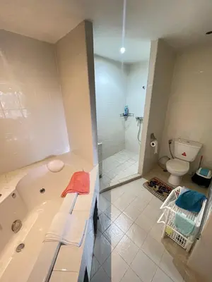 a bathroom with a bath tub and a toilet at Rawai Condominium in Ban Saiyuan (1)