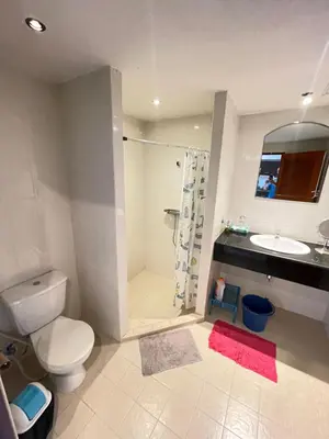 a bathroom with a toilet and a sink and a shower at Rawai Condominium in Ban Saiyuan (1)