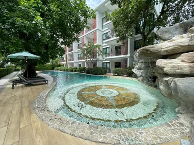 a swimming pool in front of a building at The Title Rawai Aparthotel by HSS in Rawai Beach