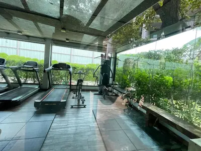 a gym with treadmills and benches and a large window at The Title Rawai Aparthotel by HSS in Rawai Beach