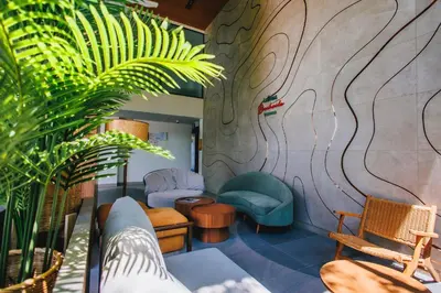 a lobby with chairs and a wall with a mural at Beachside 1 BR apartment by NLA in Bang Tao Beach