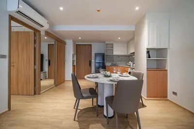 a kitchen and dining room with a table and chairs at Beachside 1 BR apartment by NLA in Bang Tao Beach